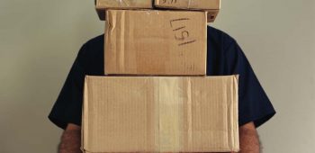 Delivery Man Balancing Boxes